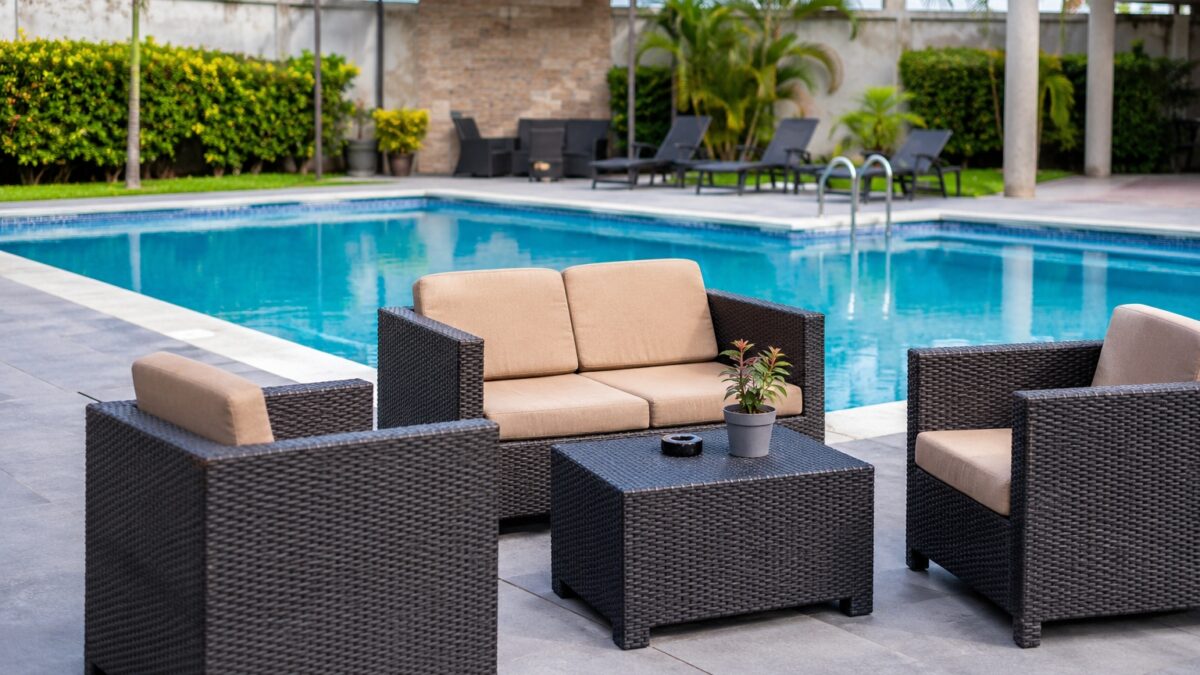 Durable pool furniture materials beside luxury swimming pool