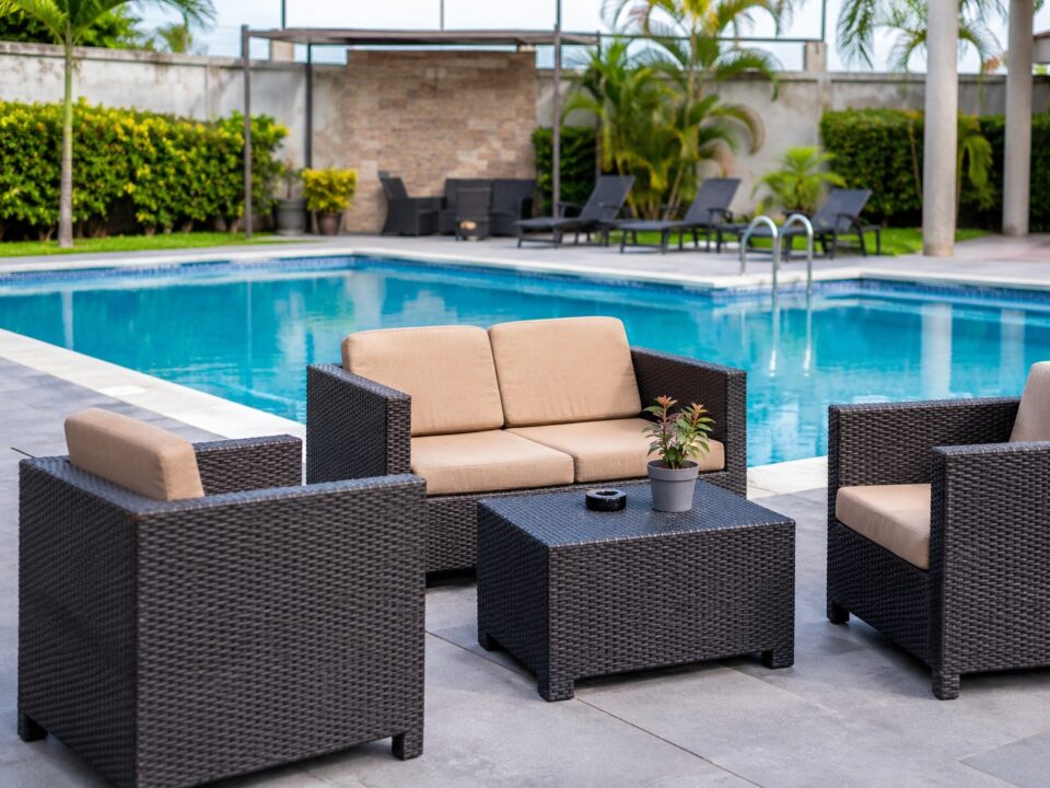 Durable pool furniture materials beside luxury swimming pool
